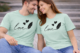 Couple wearing mint green matching love T-shirts with heart and feather design